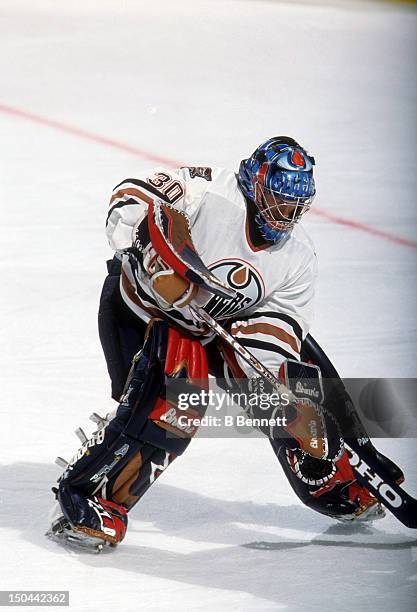 Goalie Jussi Markkanen moves the puck during a pre-season game in September, 2001 at the Skyreach Centre in Edmonton, Alberta, Canada.