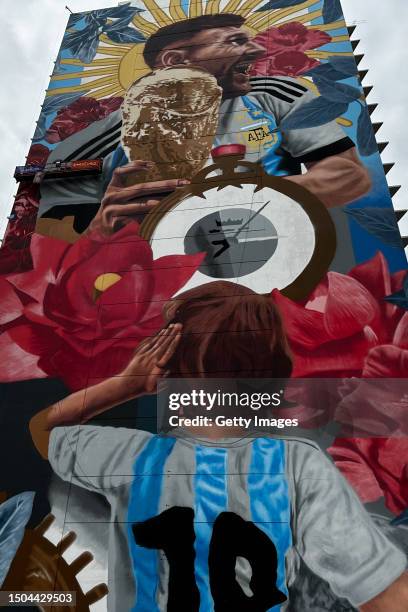 General view of a giant mural by artist Cobre depicting Argentina football player Lionel Messi with the World Cup Trophy on June 29, 2023 in Santa...