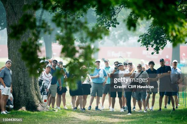 Carl Yuan of China plays his second shot on the 17th hole during the first round of the Rocket Mortgage Classic at Detroit Golf Club on June 29, 2023...