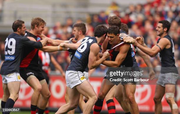 Players wrestle during the round 21 AFL match between the Essendon Bombers and the Carlton Blues at the Melbourne Cricket Ground on August 18, 2012...