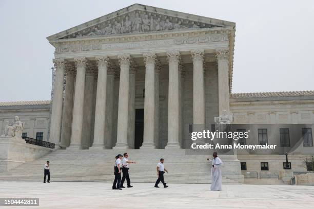 Police officers with the U.S. Supreme Court detain a man who entered the closed front plaza of the Court on June 29, 2023 in Washington, DC. In a 6-3...