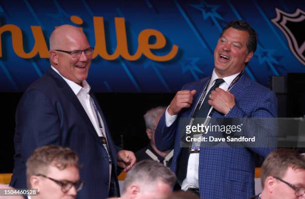 Keith Tkachuk and Bill Guerin of the Minnesota Wild laugh on the draft floor during the 2023 Upper Deck NHL Draft - Rounds 2-7 at Bridgestone Arena...