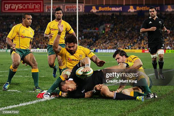 Hosea Gear of the All Blacks is tackled into touch just short of the line by Digby Ioane and Adam Ashley-Cooper of the Wallabies during The Rugby...