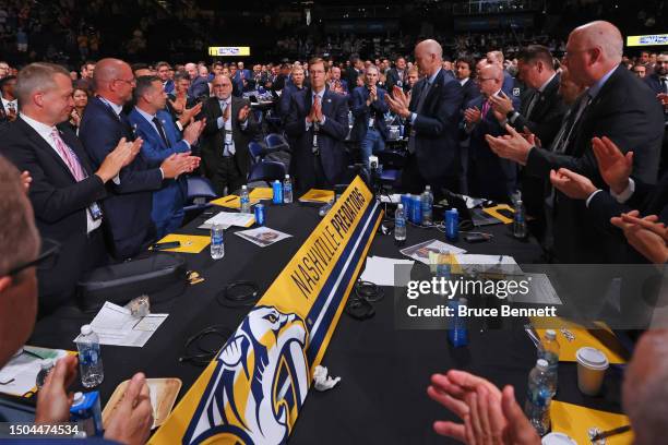 General Manager David Poile of the Nashville Predators receives a standing ovation and waves after making the 218th pick, the final of his career,...