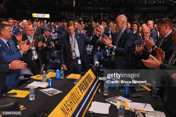 General Manager David Poile of the Nashville Predators receives a standing ovation and waves after making the 218th pick, the final of his career,...