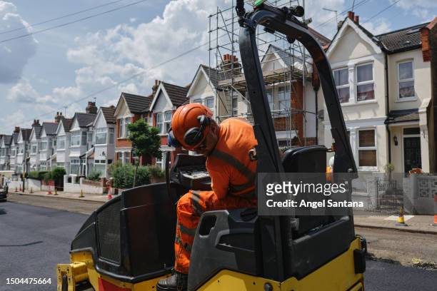 paving the way: worker driving asphalt machine - road work stock pictures, royalty-free photos & images