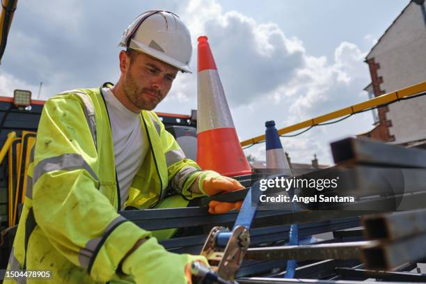 road construction and maintenance worker actively moving traffic cones on top of his work van. - safety equipment stock pictures, royalty-free photos & images