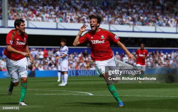 Michu of Swansea celebrates scoring the opening goal during the Barclays Premier League match between Queens Park Rangers and Swansea City at Loftus...