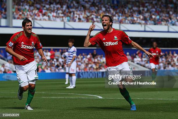 Michu of Swansea celebrates scoring the opening goal during the Barclays Premier League match between Queens Park Rangers and Swansea City at Loftus...