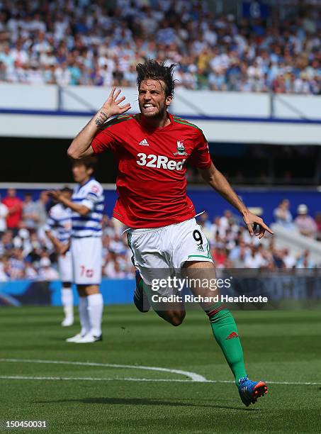 Michu of Swansea celebrates scoring the opening goal during the Barclays Premier League match between Queens Park Rangers and Swansea City at Loftus...