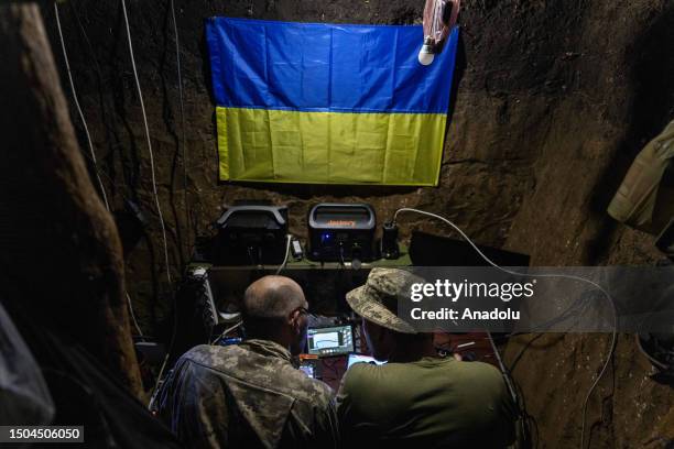 Soldiers operate a drone from their foxhole position with the 110th Brigade, a Territorial Defense unit, in Novodarivka settlement, Luhansk Oblast,...