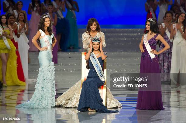 Miss World 2012 winner Yu Wenxia of China recieves the crown from the previous winner, Ivian Sarcos of Venezuela , as second place contestant Miss...