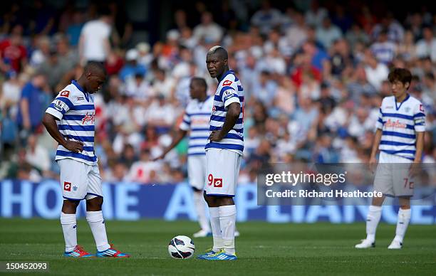 Junior Hoilett and Djibril Cisse of QPR look dejected after conceeding the fourth goal during the Barclays Premier League match between Queens Park...