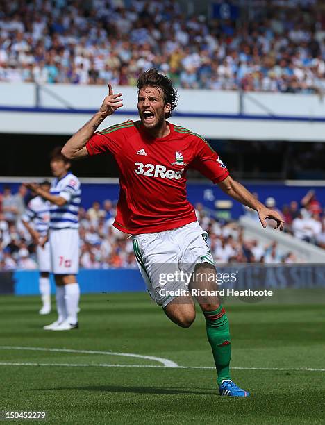 Michu of Swansea celebrates scoring the opening goal during the Barclays Premier League match between Queens Park Rangers and Swansea City at Loftus...