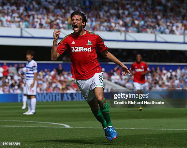 Michu of Swansea celebrates scoring the opening goal during the Barclays Premier League match between Queens Park Rangers and Swansea City at Loftus...