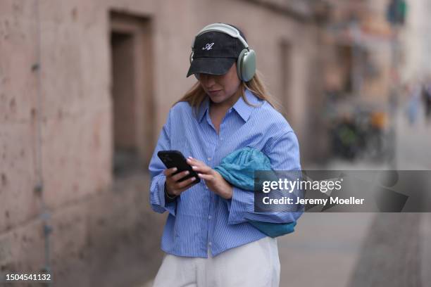 Sonia Lyson wearing Copenhagen Studios black and white sneaker, Zara hose, Storets blue and white striped long sleeve buttoned cropped flannel,...