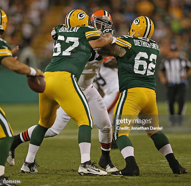 Don Barclay and Evan Dietrich-Smith of the Green Bay Packers block Kiante Tripp of the Cleveland Browns during a preseason game at Lambeau Field on...