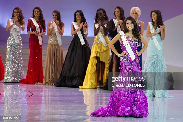 Miss Indonesia Ines Tjiptadi poses before other contestants during the Miss World 2012 final ceremony at Dongsheng Stadium in the inner Mongolian...