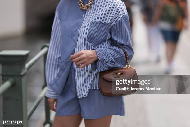 Sonia Lyson wearing Gold Zara statement link chain, Storets matching two piece set includes a buttoned blue and white striped flannel and shorts and...