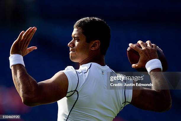 Quarterback Russell Wilson of the Seattle Seahawks warms up before a game against the Denver Broncos at Sports Authority Field Field at Mile High on...