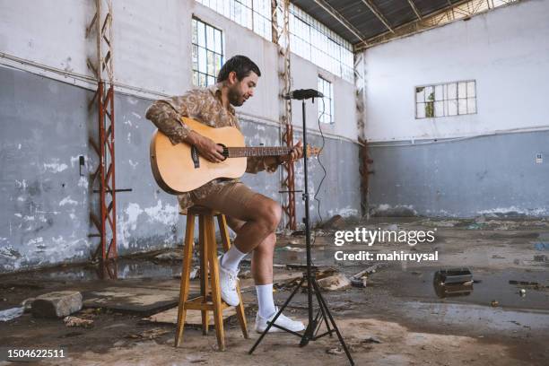 young musician playing guitar - alternative lifestyle stock pictures, royalty-free photos & images