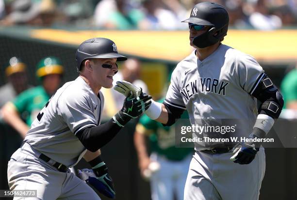 Josh Donaldson of the New York Yankees is congratulated by Harrison Bader after Donaldson hit a two-run home run against the Oakland Athletics in the...