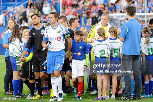 Members of the Montreal Impact and San Jose Earthquakes take to the field prior to the match at the Saputo Stadium on August 18, 2012 in Montreal,...