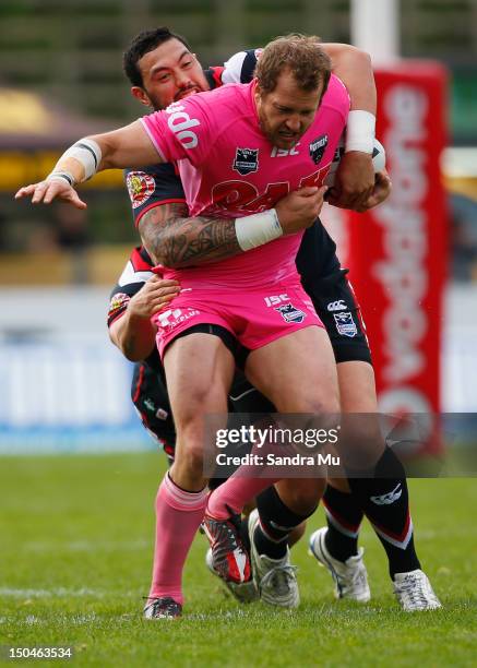 Clint Newton of the Panthers is tackled during the round 24 NRL match between the Warriors and the Penrith Panthers at Mt Smart Stadium on August 19,...