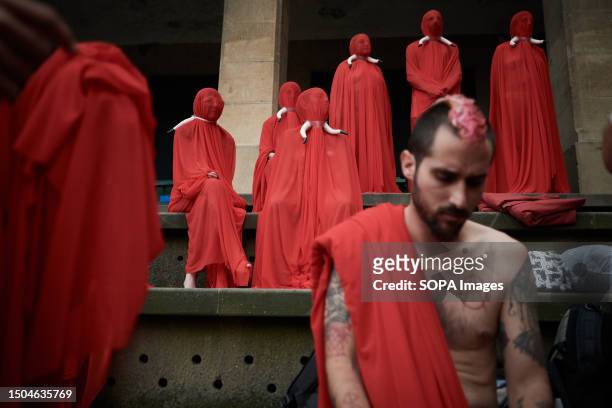 Peta protesters, prepare for the performance against animal abuse in Pamplona one day before the San Fermín festivities Bull fighting is an important...