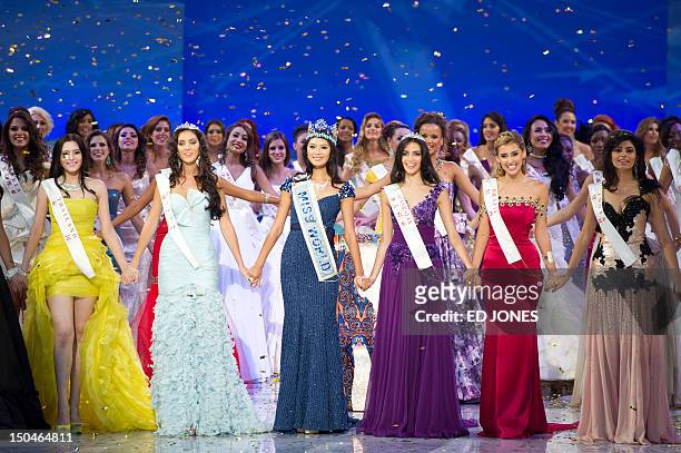Photo taken on August 18, 2012 shows Miss Thailand Vanessa Herrmann, second place Miss Wales Sophie Moulds, winner Miss China Yu Wenxia, Miss...