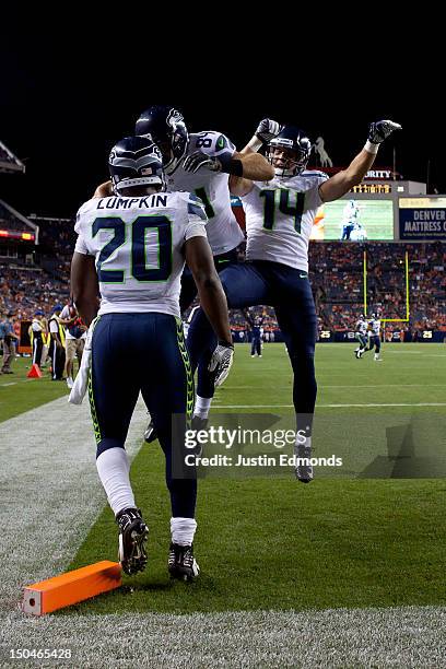 Cooper Helfet of the Seattle Seahawks celebrates his 9 yard touchdown reception with teammates running back Kregg Lumpkin and wide receiver Charly...