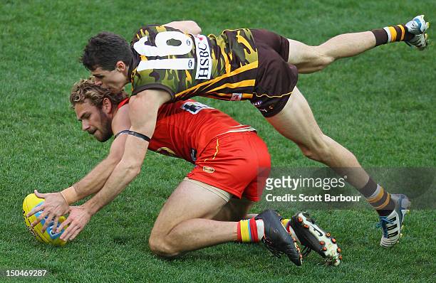 Isaac Smith of the Hawks and Jared Brennan of the Suns compete for the ball during the round 21 AFL match between the Hawthorn Hawks and the Gold...