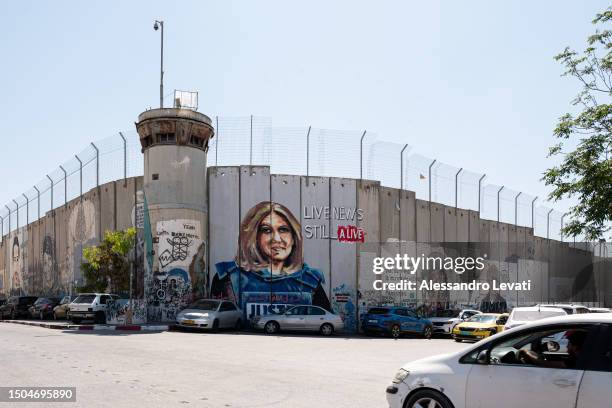 In Bethlehem many artists painted the wall on the Palestinian side with different murals. This drawing depicts Palestinian Al Jazeera journalist...