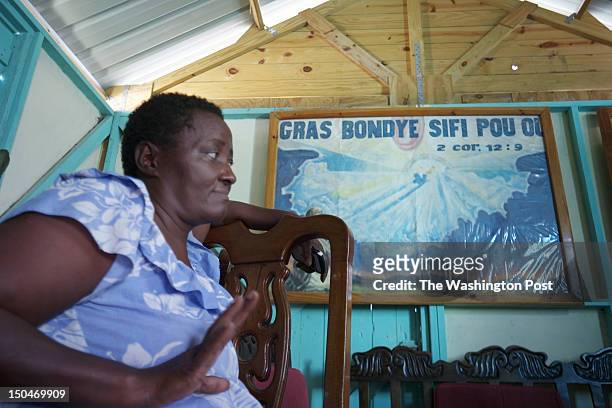 Mimose Brinyol sits in the front room of the new home she shares with 7 family members in Ravine Pintade, a transformed hilly area in Haitian...