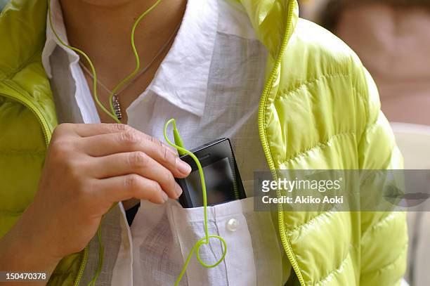 smartphone in pocket - jacket pocket stock pictures, royalty-free photos & images