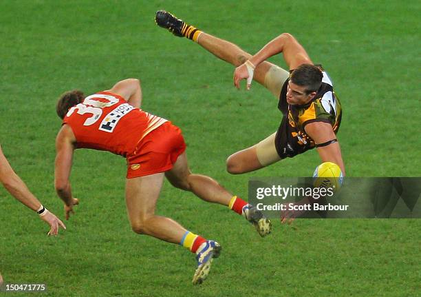 Ben Stratton of the Hawks and Campbell Brown of the Suns compete for the ball during the round 21 AFL match between the Hawthorn Hawks and the Gold...