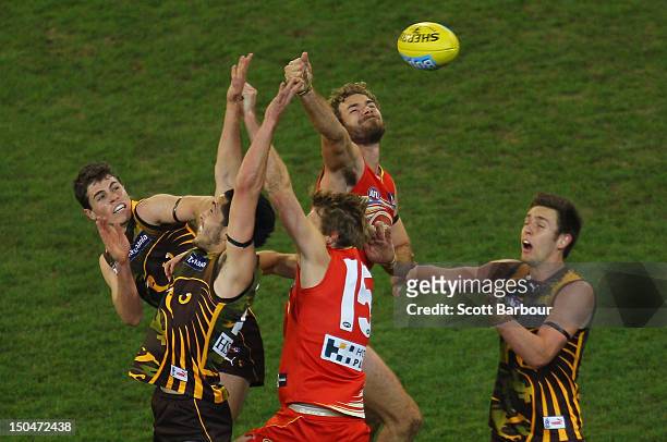 Shane Savage of the Hawks and Piers Flanagan of the Suns compete for the ball during the round 21 AFL match between the Hawthorn Hawks and the Gold...