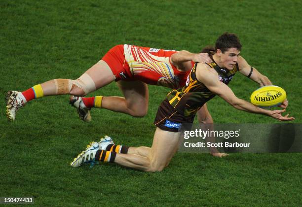 Isaac Smith of the Hawks is tackled by Danny Stanley of the Suns during the round 21 AFL match between the Hawthorn Hawks and the Gold Coast Suns at...