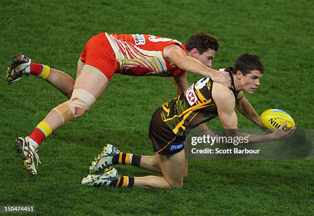 Isaac Smith of the Hawks is tackled by Danny Stanley of the Suns during the round 21 AFL match between the Hawthorn Hawks and the Gold Coast Suns at...