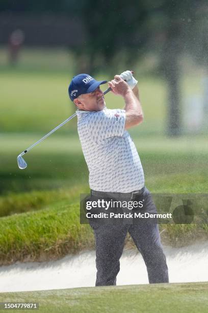 Rod Pampling of Australia plays from a fairway bunker on the sixth hole during the first round of the U.S. Senior Open Championship at SentryWorld on...