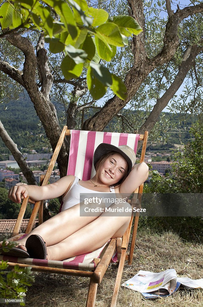 Teenage sitting in deckchair smiling