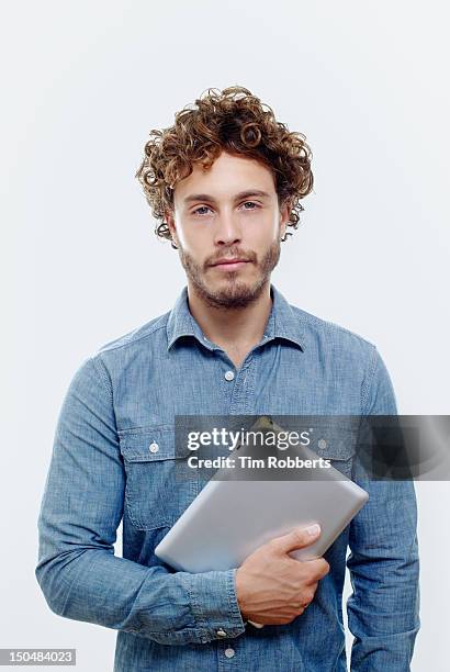 man holding digital tablet. - curly hair man stock pictures, royalty-free photos & images