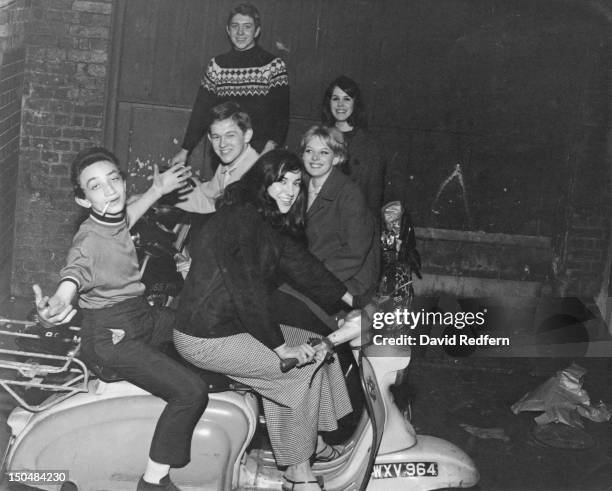 Group of mods posing on their scooters outside The Scene club in Soho, London, circa 1964.