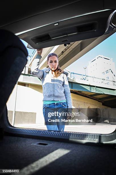 woman looking into empty trunk - kofferraum leer stock-fotos und bilder