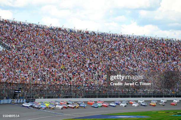 Mark Martin, driver of the Aaron's Dream Machine Toyota, leads the field to the start of the NASCAR Sprint Cup Series Pure Michigan 400 at Michigan...