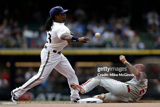 Rickie Weeks of the Milwaukee Brewers try to turn the double play as Kevin Frandsen of the Philadelphia Phillies slides into second base during the...