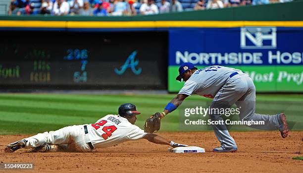 Michael Bourn of the Atlanta Braves steals second base against Hanley Ramirez of the Los Angeles Dodgers at Turner Field on August 19, 2012 in...