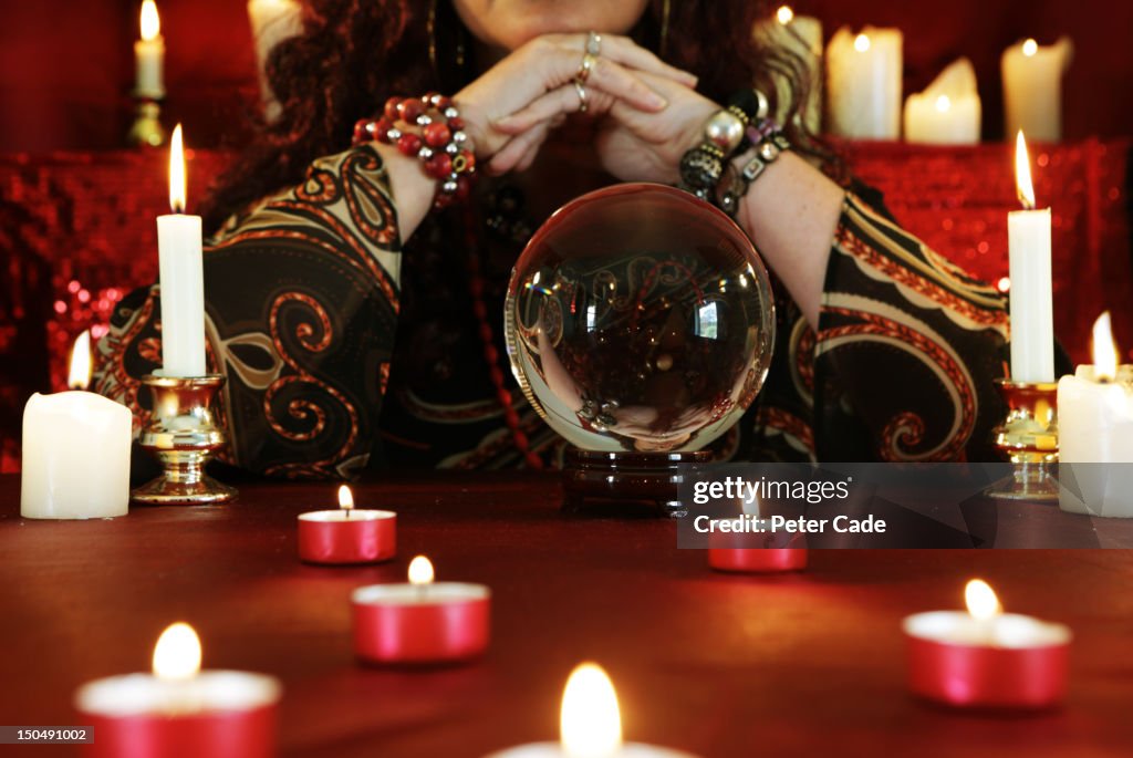 Fortune teller, candles and crystal ball