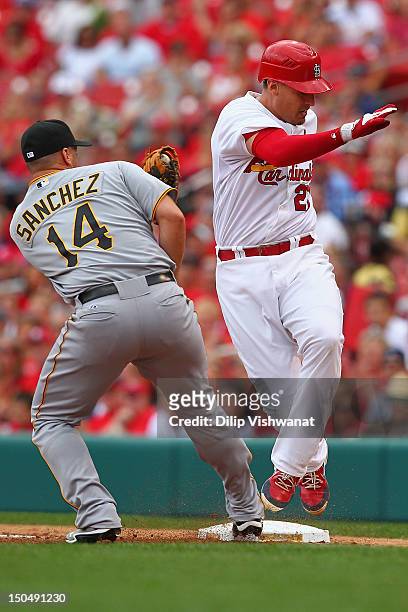 Allen Craig of the St. Louis Cardinals avoids being tagged out at first base by Gaby Sanchez of the Pittsburgh Pirates at Busch Stadium on August 19,...
