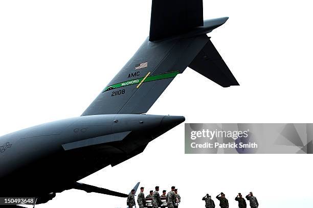 Army soldiers carry the flag-draped transfer case containing the remains of U.S. Army Spc. Richard A. Essex during a dignified transfer at Dover Air...